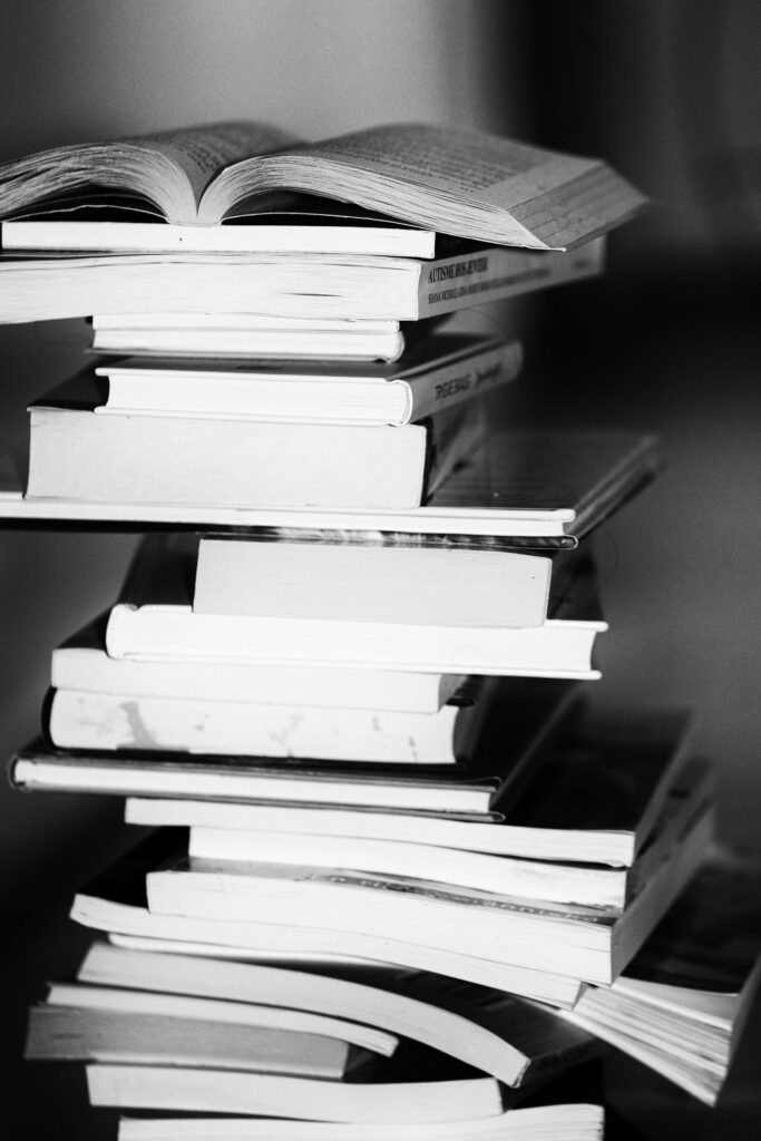 pexels-photo-433333-433333 A monochrome image of a tall stack of books symbolizing education and knowledge.